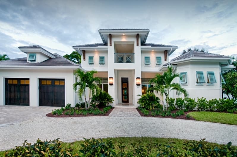 Modern house plan exterior with two-story design, hip roof, balconies, and a three-car garage.