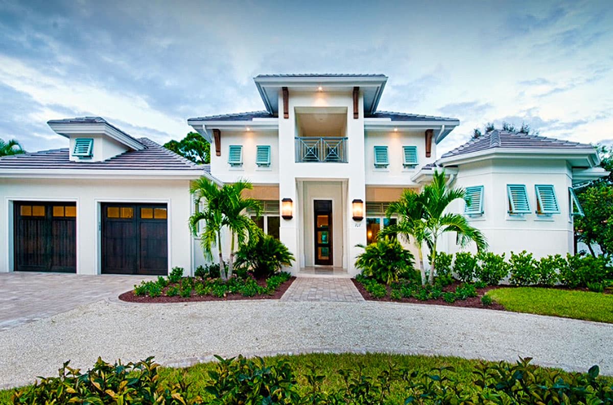 House plan exterior: Two-story Modern style with a central balcony, dual garage doors, tiled roof, and louvered shutters.