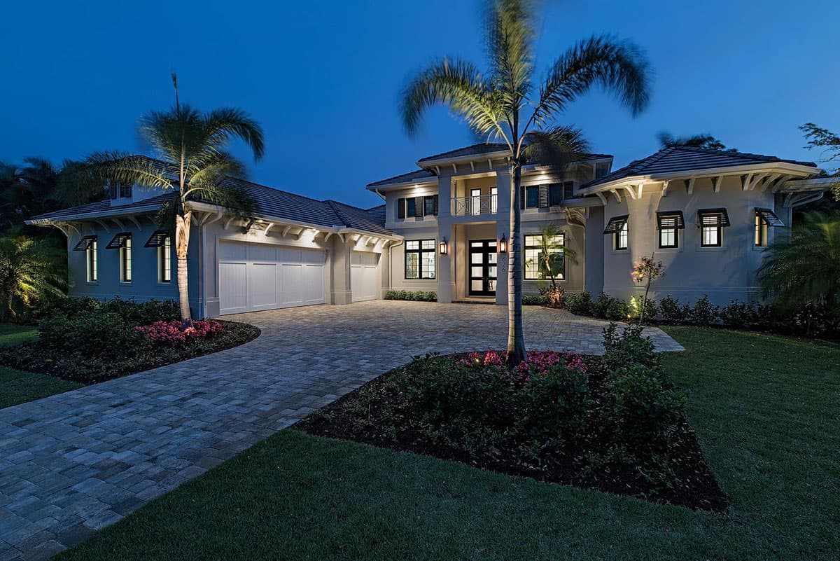 House plan exterior. Two-story Mediterranean style with a multi-car garage, multiple gables, and a prominent entry balcony.