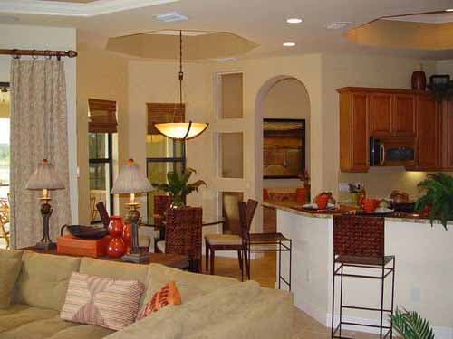 Open concept living space with kitchen island, dining area, and living room featuring sectional sofa.