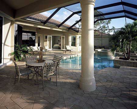 Covered patio with screened enclosure, pool, spa, outdoor dining set, and Tuscan-style column.