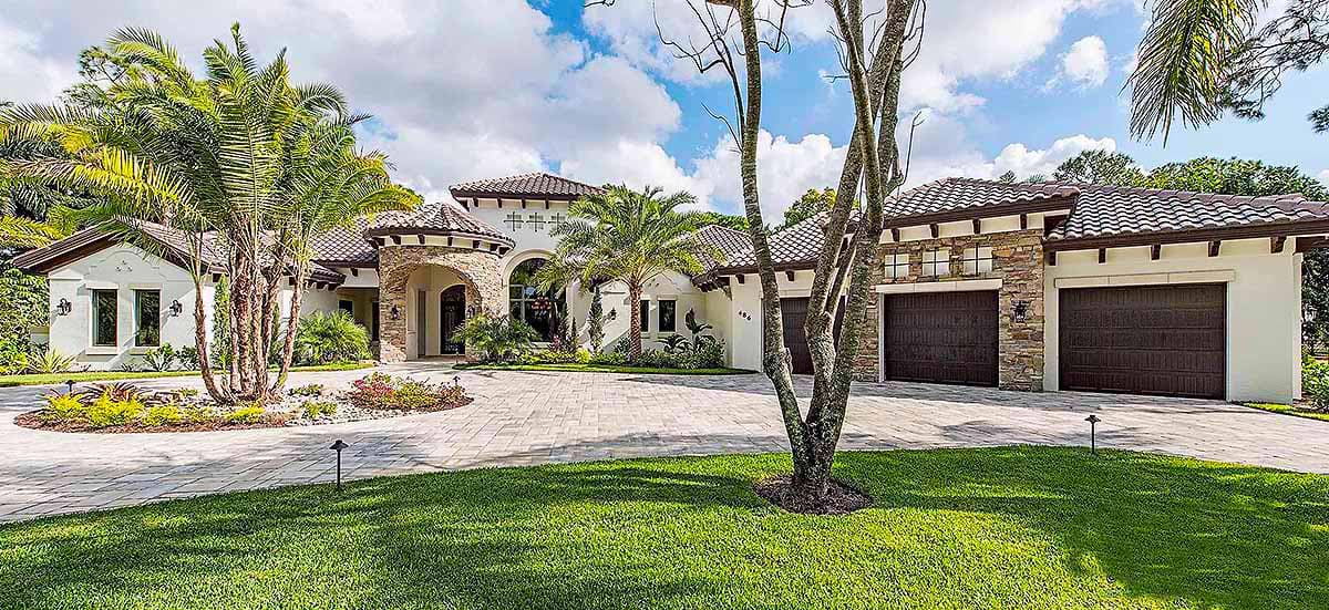 House plan exterior. Two-story Mediterranean-style home with arched entry, tiled roof, and two garage bays.