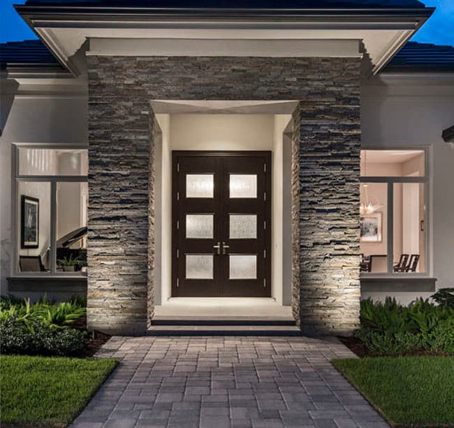 Modern house plan exterior with double entry doors, stone accent pillars, and large adjacent windows.