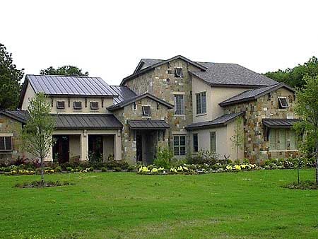 House plan exterior featuring stone and stucco, multiple gables, dormers, and a metal roof.