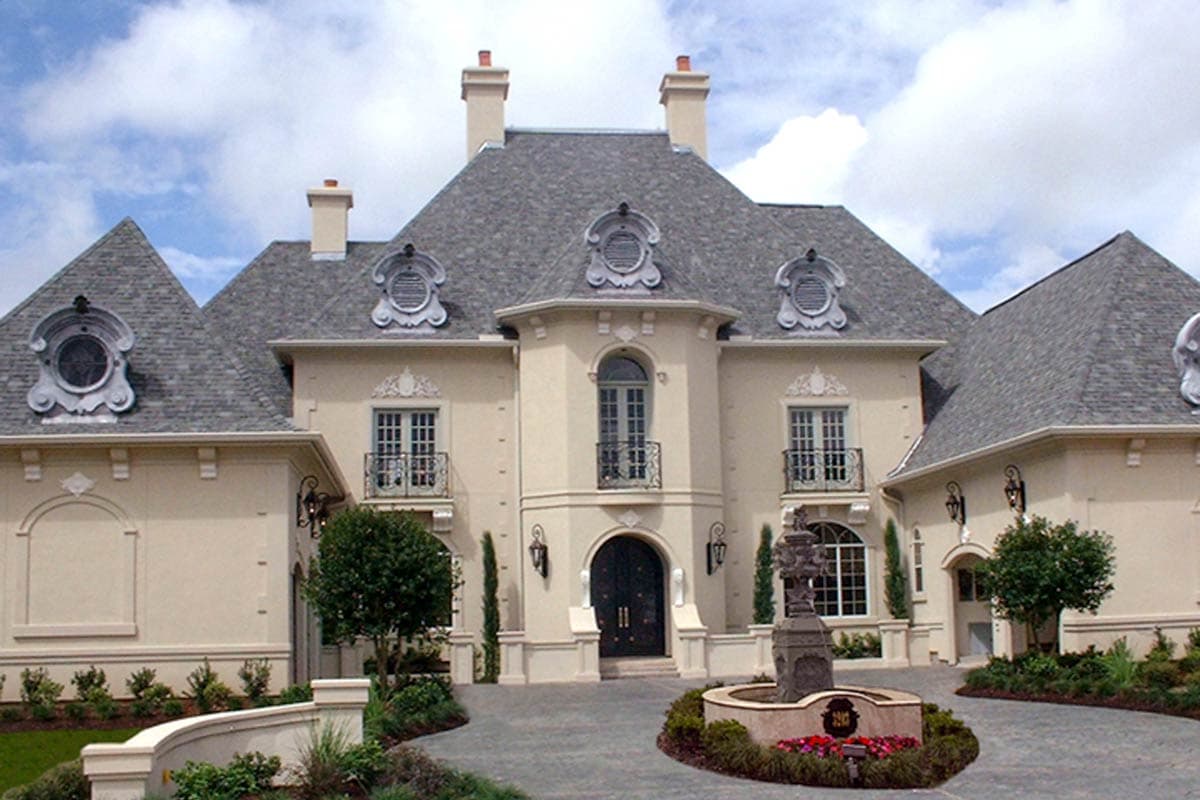 House plan exterior: French style, mansard roof, multiple gables, arched windows, balconies, and decorative dormers.