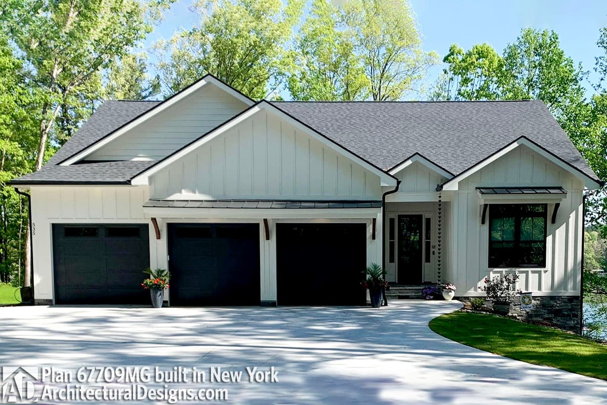 House plan exterior: Modern Farmhouse, one story, white board and batten, three-car garage with dark doors, gable rooflines.