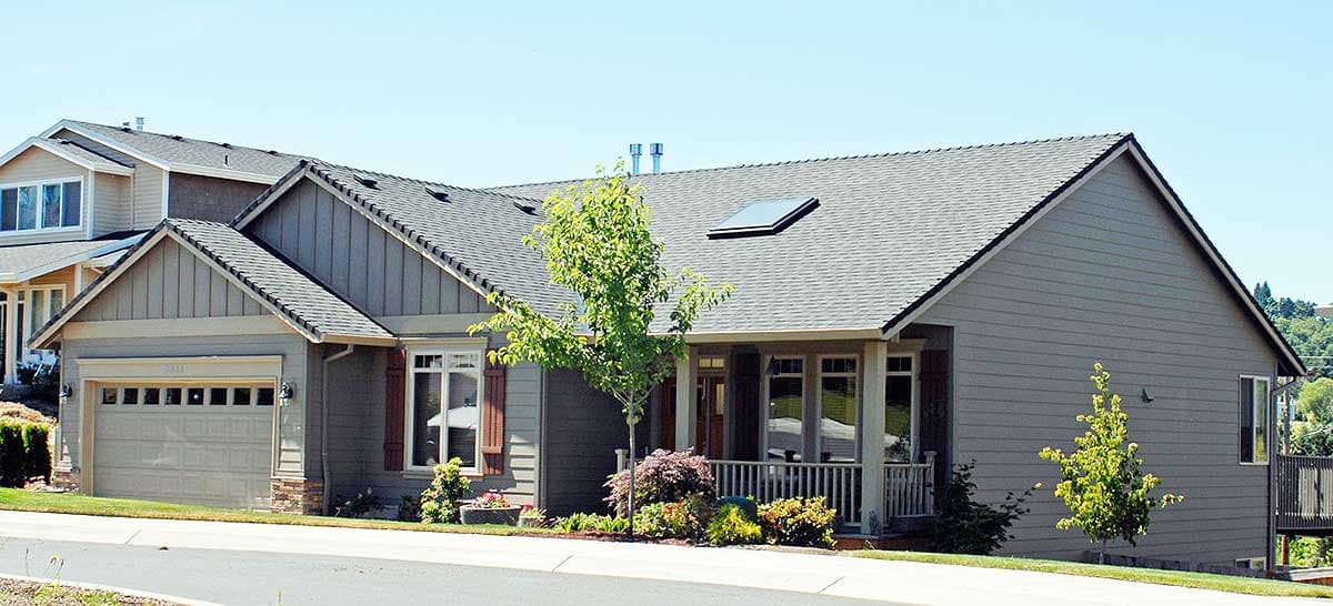 House plan exterior: Modern Farmhouse style, one story, with a front porch, gables, and a side-facing garage.