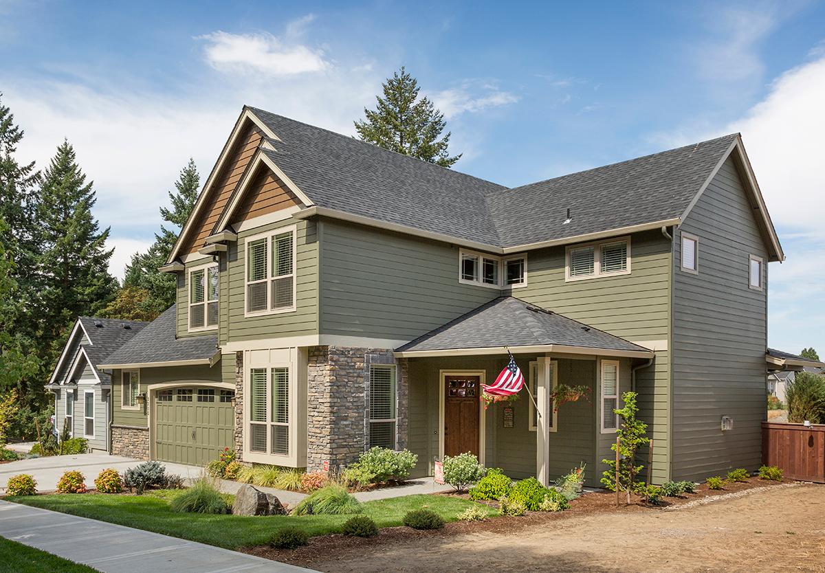 House plan exterior: Two-story Modern Farmhouse with gables, stone accents, covered entry, and attached garage.