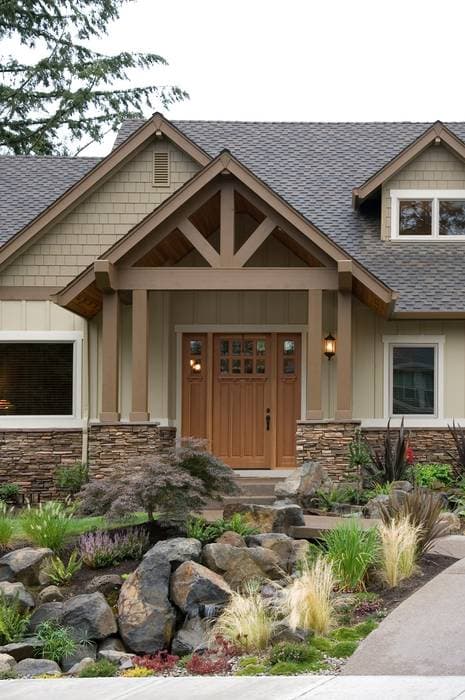 Craftsman style house plan exterior with timber frame entrance, stone accents, and shingle siding.