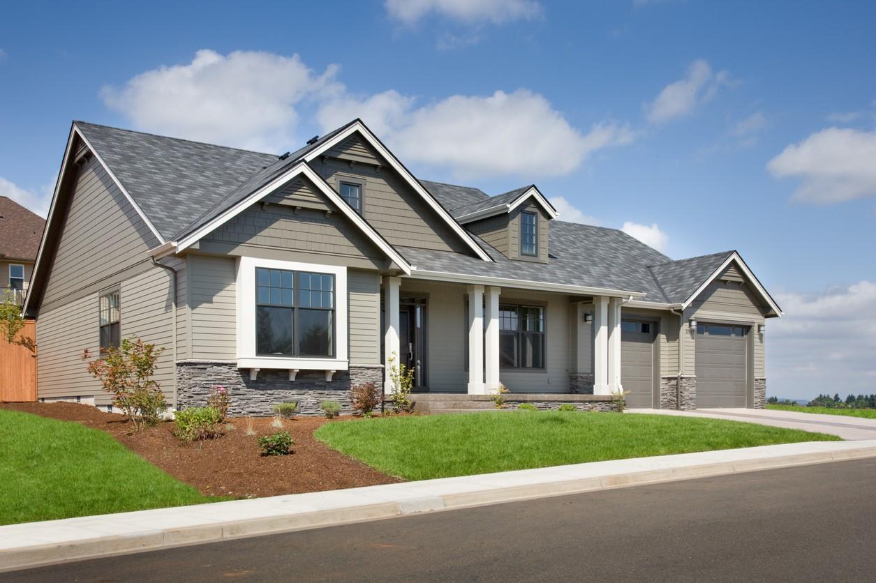 House plan exterior: Single-story Modern Farmhouse with covered porch, dormers, prominent gables, and a side-facing two-car garage.