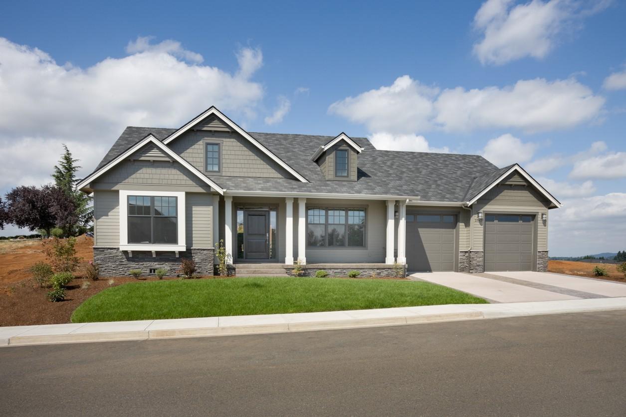 Craftsman style house plan exterior with a covered porch, gables, dormers, and a two-car garage.