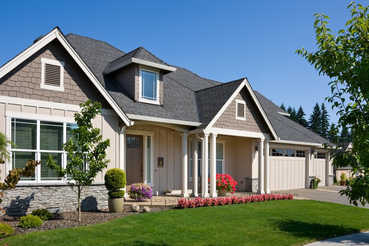 House plan exterior: Two-story Modern Farmhouse with gabled dormer, stone accents, covered porch, and attached three-car garage.