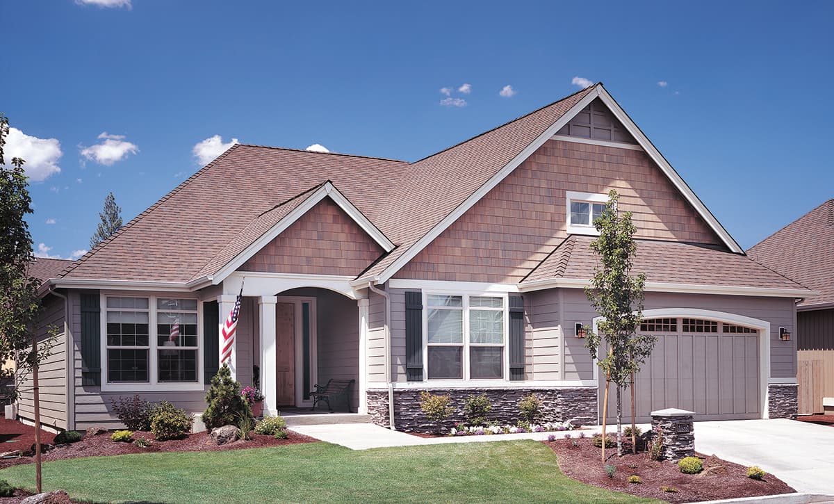 House plan exterior: One-story Modern Farmhouse with covered entry, shingle siding, stone accents, and attached garage.