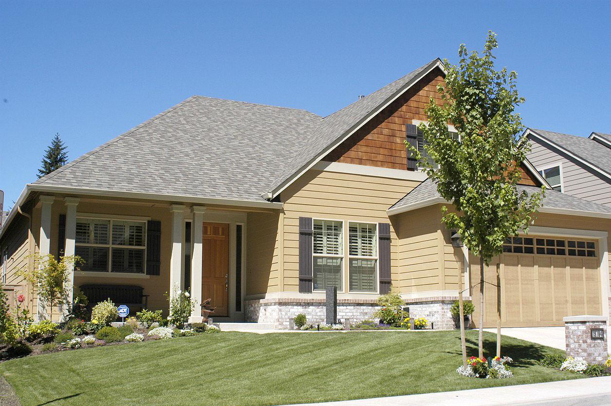House plan exterior: One-story Modern Farmhouse with covered entry porch, gabled dormer, and attached two-car garage.