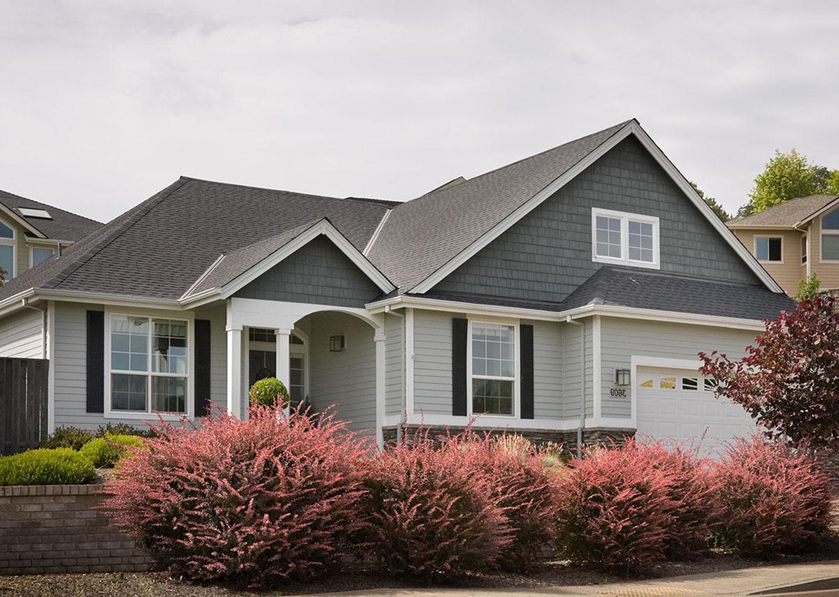 House plan exterior: Ranch style, one story, with covered entry, gabled dormers, and attached garage.