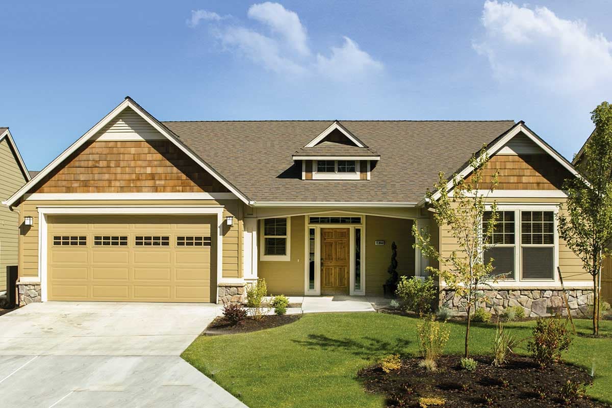 House plan exterior: Craftsman style, one-story, with a covered entry porch, dormer, gabled roof, and attached garage.