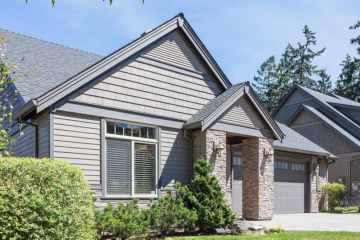 House plan exterior: two-story Modern Farmhouse with stone accents, gabled rooflines, and a two-car garage.