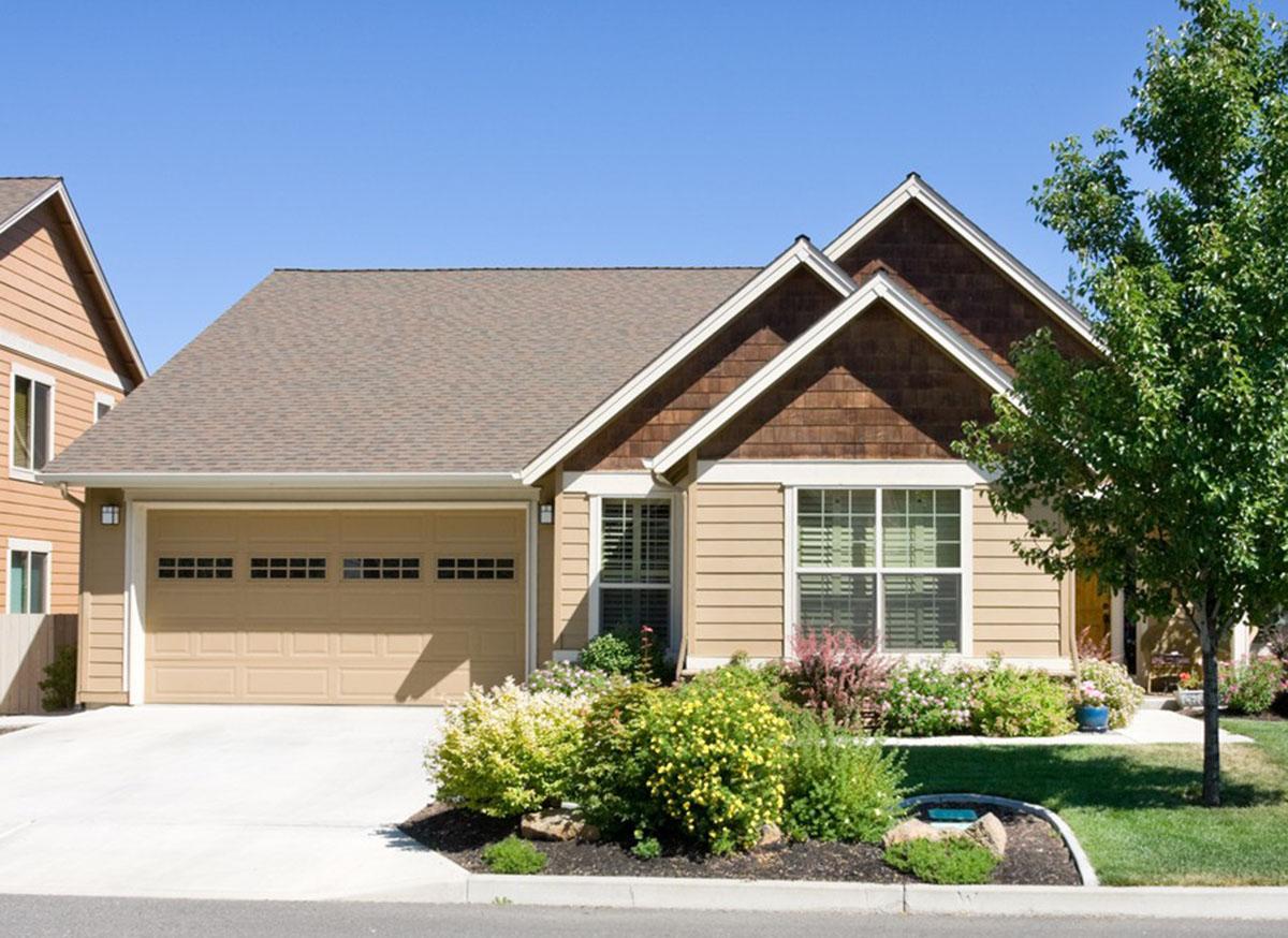 House plan exterior: One-story modern farmhouse with attached garage, gable roof, and cedar shake accents.