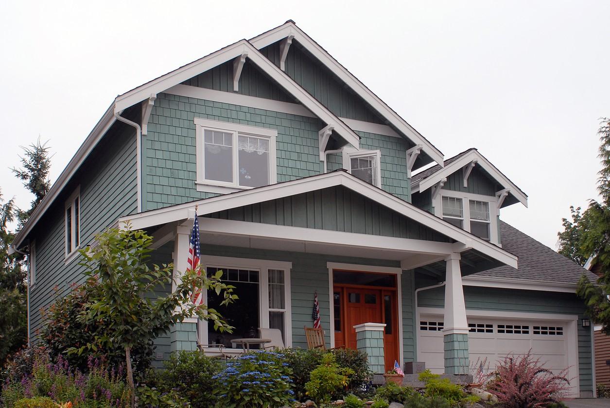 Craftsman style house plan exterior with shingle siding, prominent gables, dormers, covered entry porch, and attached garage.