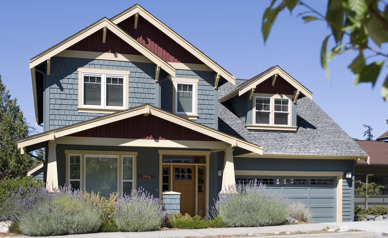 Craftsman house plan exterior: two stories, hip roof, prominent gables, covered entry, and side-facing garage.