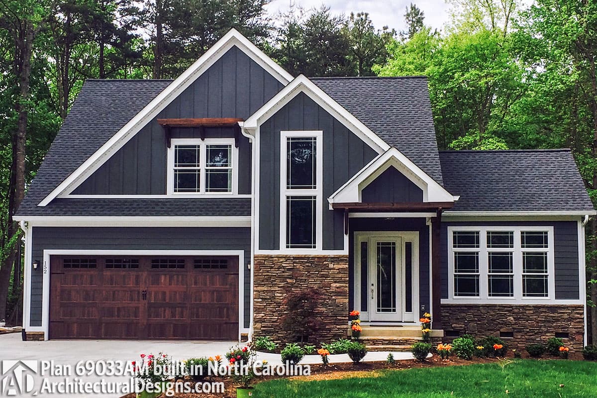 House plan exterior: Modern Farmhouse style, 2 stories, stone base, gable roofline, double garage door, and covered entryway.