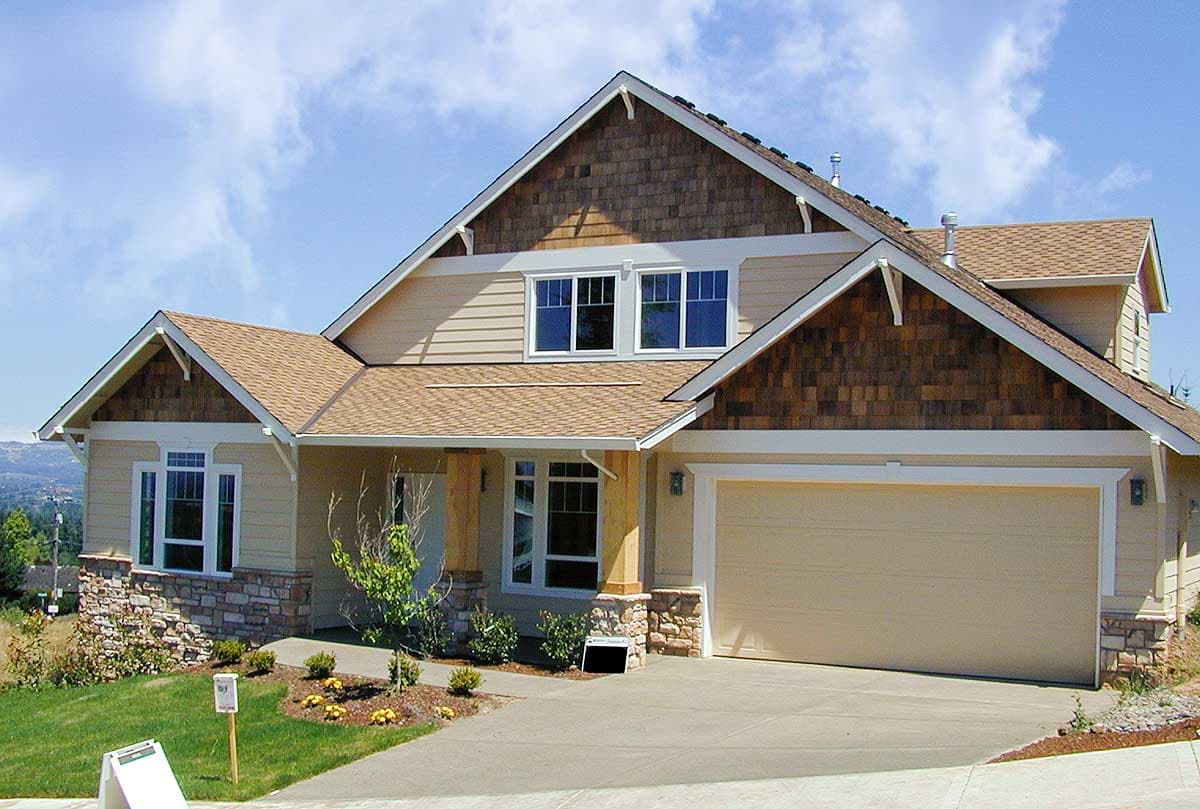 House plan exterior: Two-story Modern Farmhouse with gables, cedar shingles, stone accents, and attached garage.