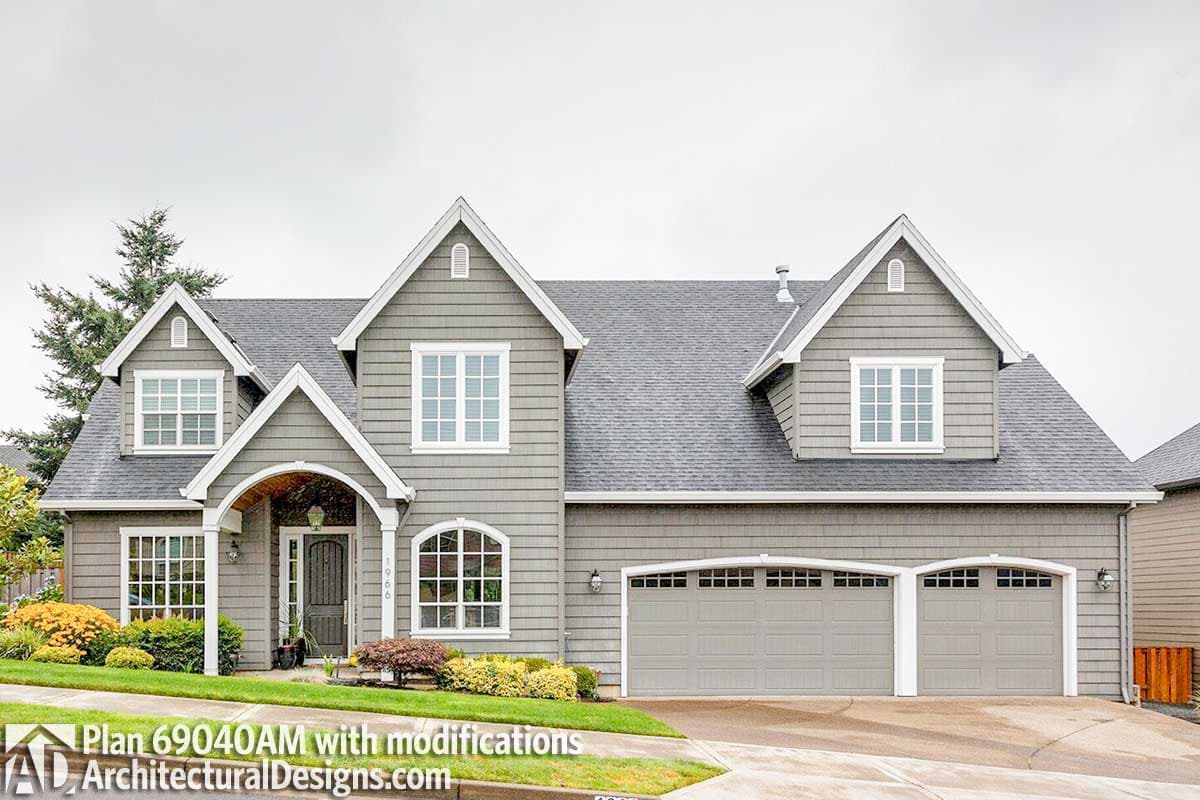 House plan exterior: Two-story Modern Farmhouse with arched entry, multiple gables, and a three-car garage.