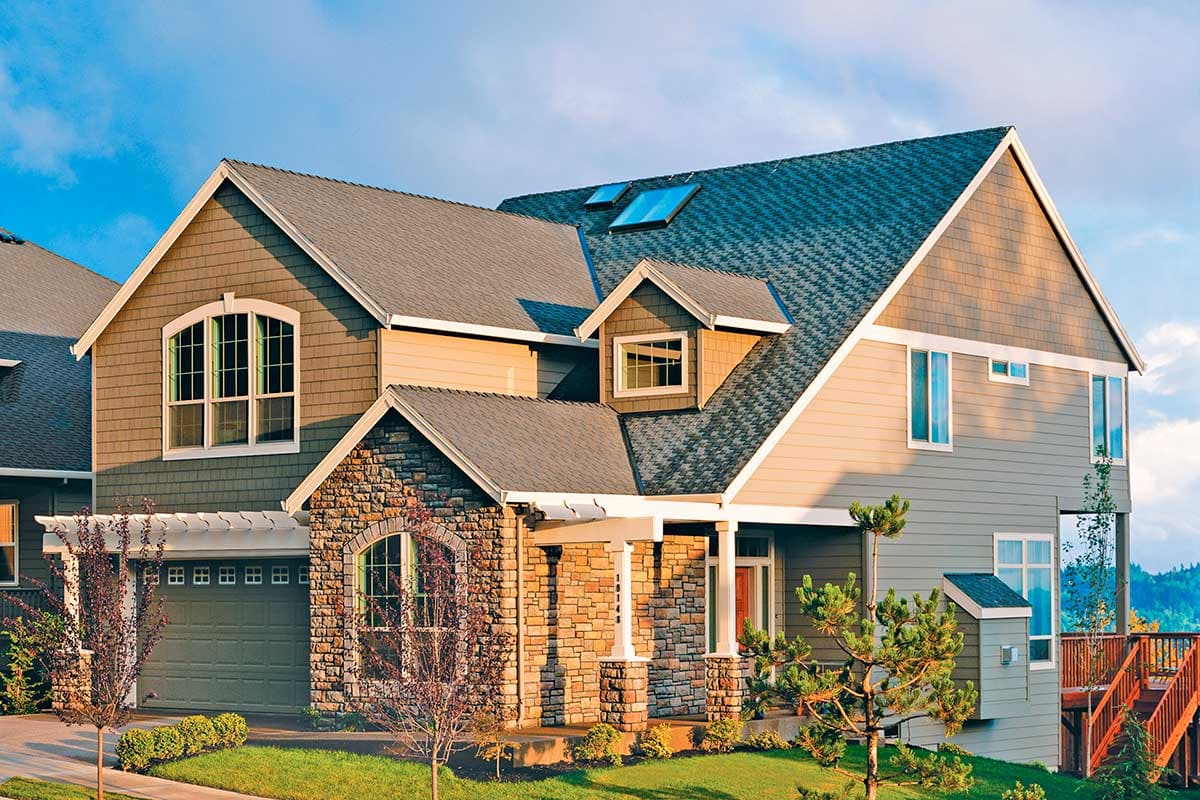 House plan exterior featuring a two-story Craftsman style home with stone accents, multiple gables, a covered porch, and a garage.