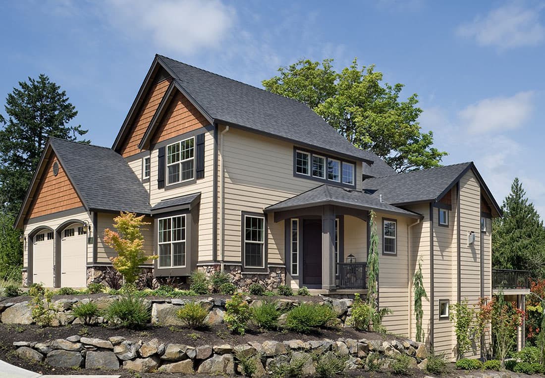 House plan exterior: Two-story Modern Craftsman with stone accents, covered entry porch, multiple gables, and a side-facing double garage.