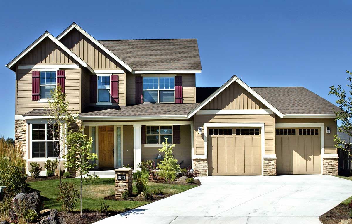 House plan exterior: Two-story Modern Farmhouse with gabled roof, covered front porch, stone accents, and a three-car side-entry garage.