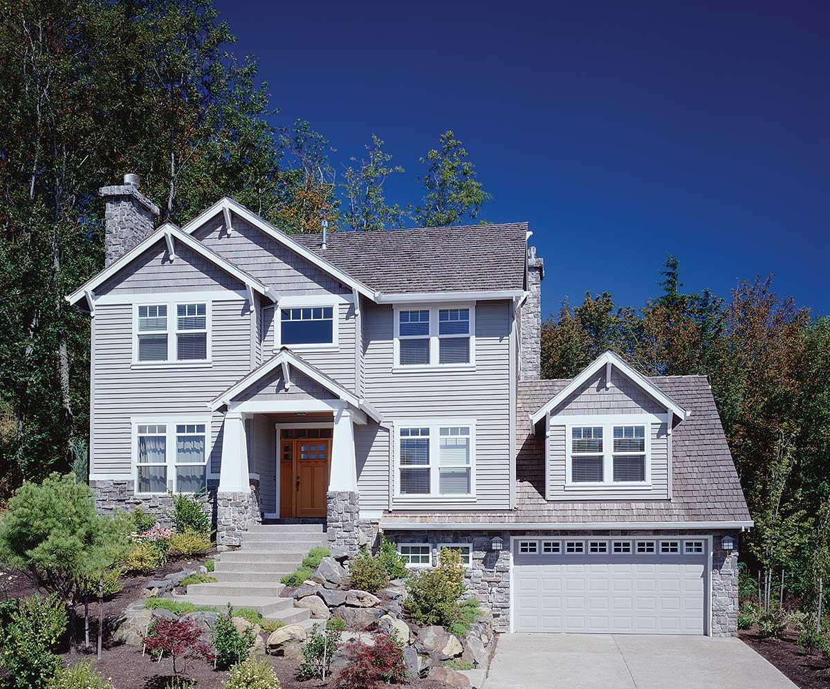 House plan exterior: Two-story home with shingle siding, stone accents, covered entry, gables, and attached garage.