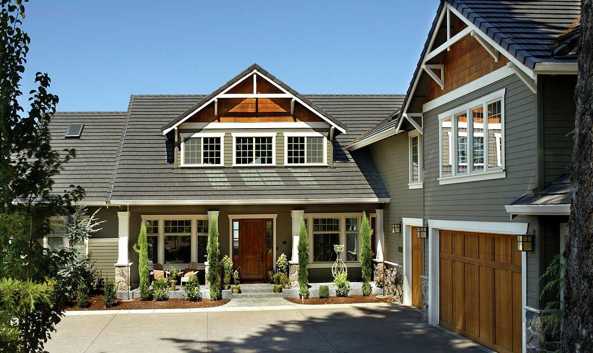 Craftsman style house plan exterior with covered entry porch, multiple gables, dormer window, and attached garage.