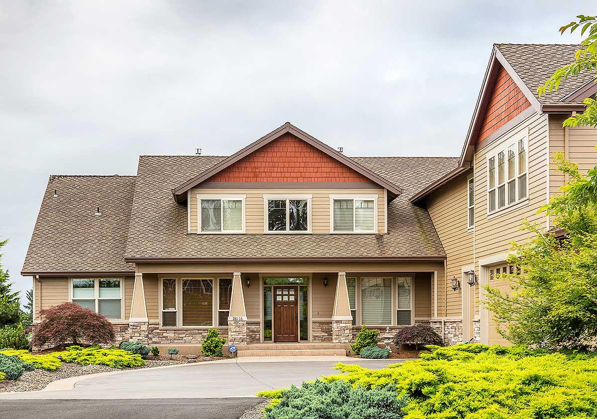 Two-story house plan exterior with a covered porch, multiple gables, stone accents, and a side-entry garage.