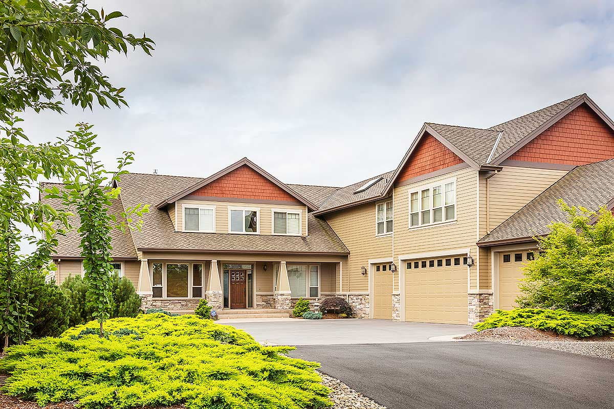 House plan exterior showing a two-story home with a covered porch, multiple gables, and a three-car garage.