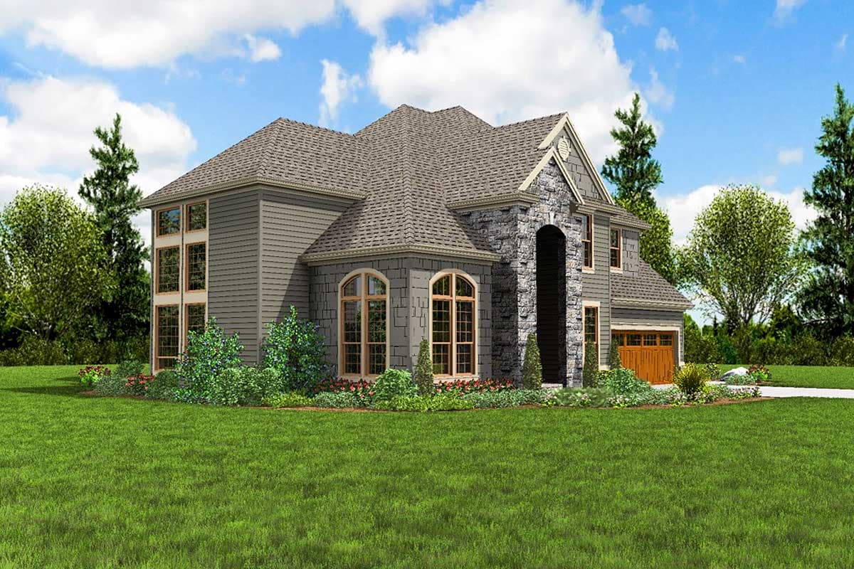 House plan exterior: Two-story home with stone accents, arched windows, steep rooflines, multi-pane windows, and a two-car garage.