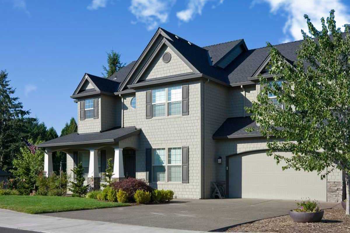 House plan exterior of a two-story home with gables, dormers, covered porch, and attached garage.
