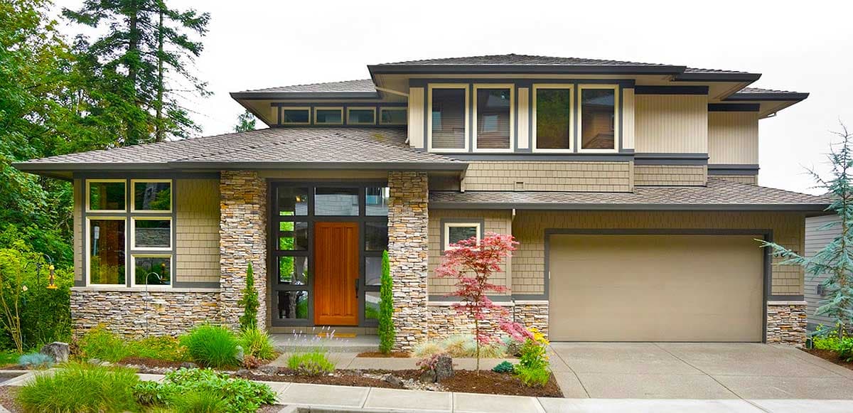 House plan exterior with stone accents, multiple gables, wide windows, and a prominent wood door.