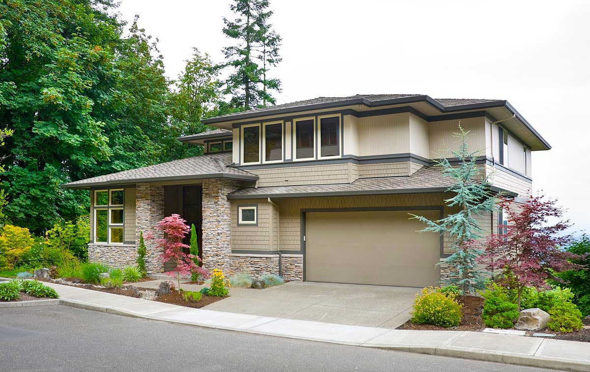 House plan exterior: Modern style, two stories, stone accents, multi-level rooflines, and a front-facing garage.