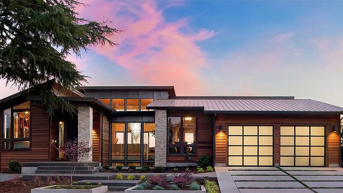 House plan exterior with modern design. Features include flat rooflines, stone column, and glass-paneled garage door. Two story design.