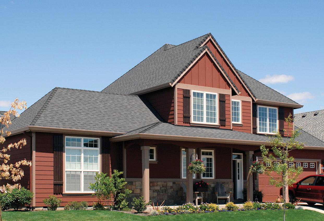 House plan exterior: two-story home with covered porch, stone accents, multiple gables, and a dormer.