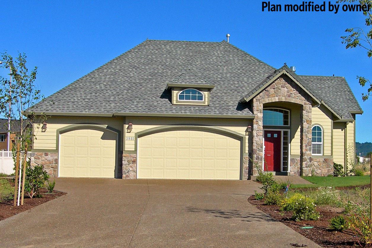 House plan exterior: One-story home with a three-car garage, arched entry with stone surround, and a dormer.