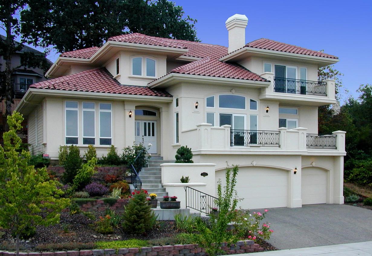 House plan exterior featuring a stucco finish, clay tile roof, arched garage doors, balconies with wrought iron railings, and a prominent chimney.