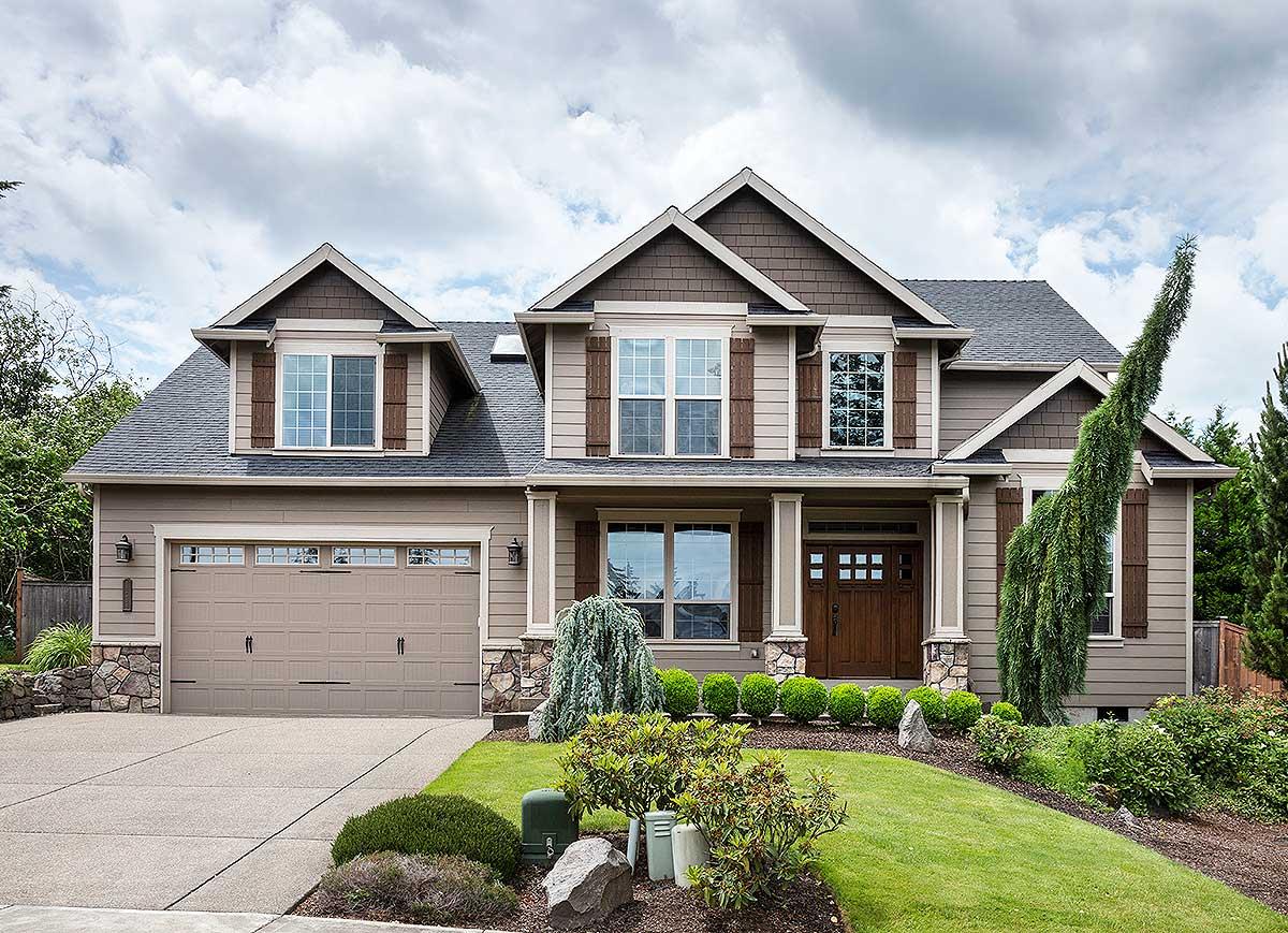 House plan exterior: Two-story home with covered entry, gabled dormers, and a side-facing garage.