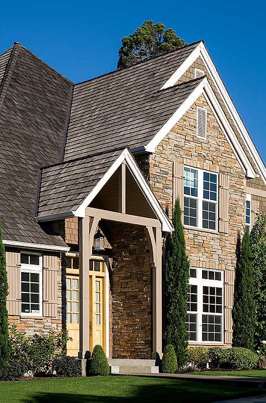 House plan exterior shows a two-story home with stone and shingle siding, gabled roof, and covered entry.