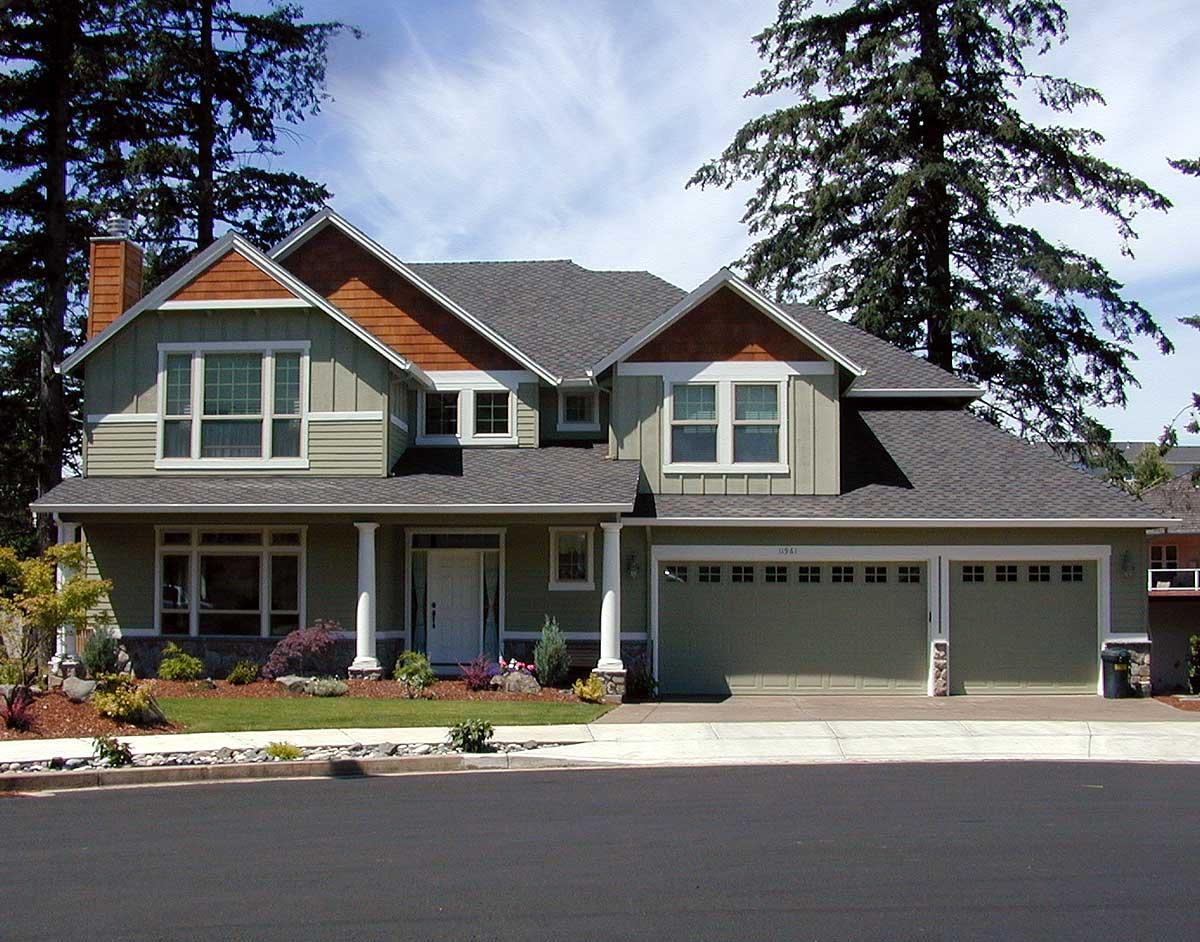 House plan exterior with gabled dormers, covered entry with columns, and a side-facing three-car garage.