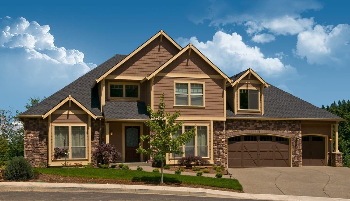 Craftsman style house plan exterior with stone accents, multiple gables, dormers, and a three-car garage.