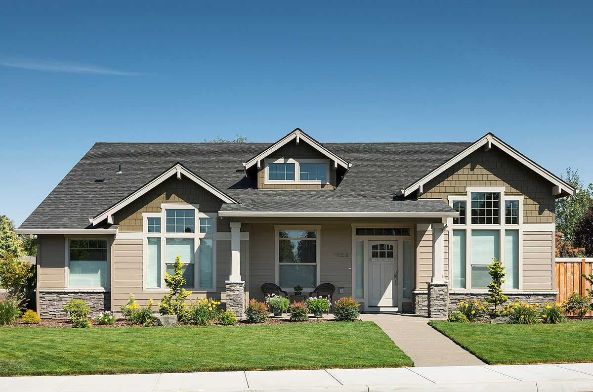 Craftsman style house plan exterior with two stories, a covered porch, dormer windows, and stone accents.