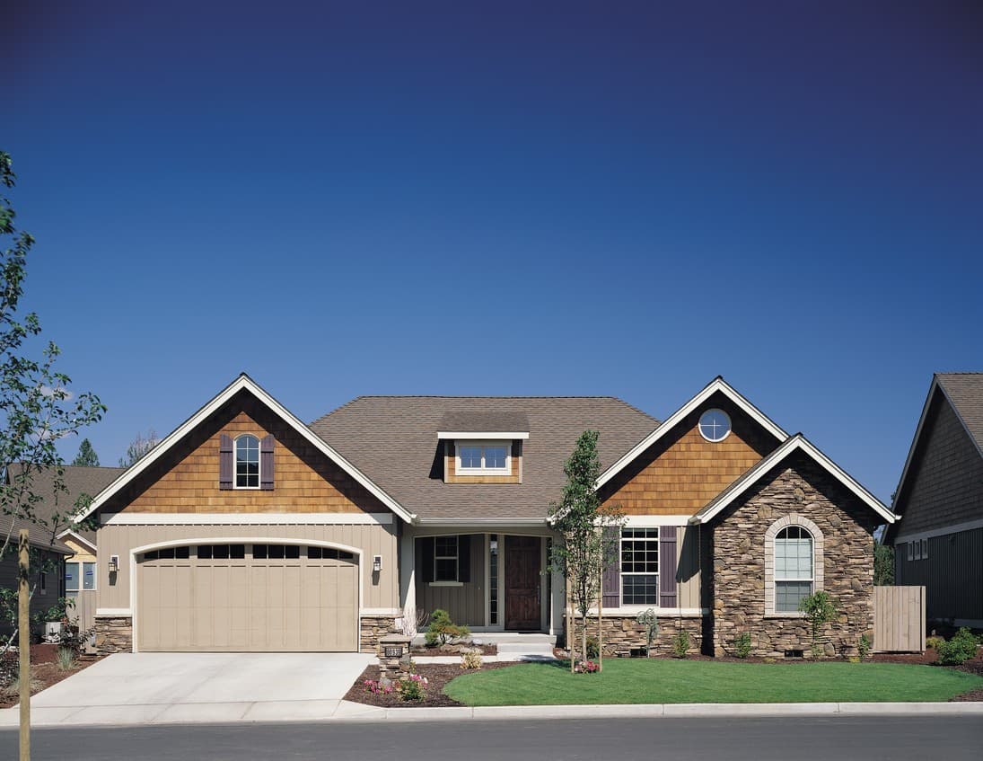 House plan exterior featuring gabled rooflines, shingle siding, stone accents, and a two-car garage.