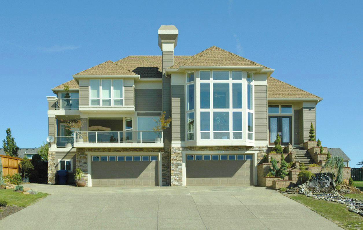 House plan exterior: Modern style, two stories, two garage doors, balconies, and a multi-story bay window.