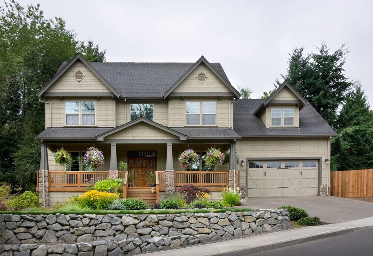 Craftsman-style house plan exterior with a two-story design, front porch, multiple gables, and an attached garage.